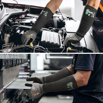 Person wearing gloves working on a car engine and using a computer in a workshop.
