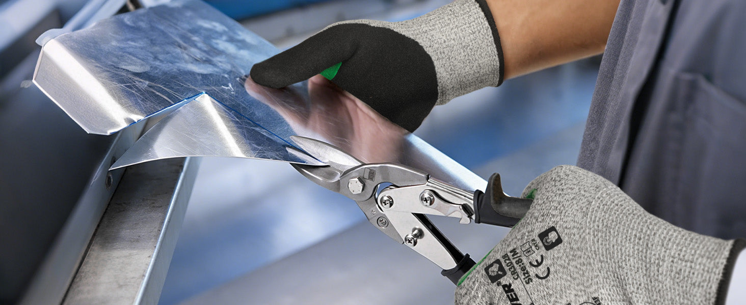 Person using a pair of pliers to cut metal with a clear blue sky in the background