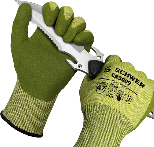 Pair of green Schwer CR3009 protective cut resistant work gloves holding a serrated knife