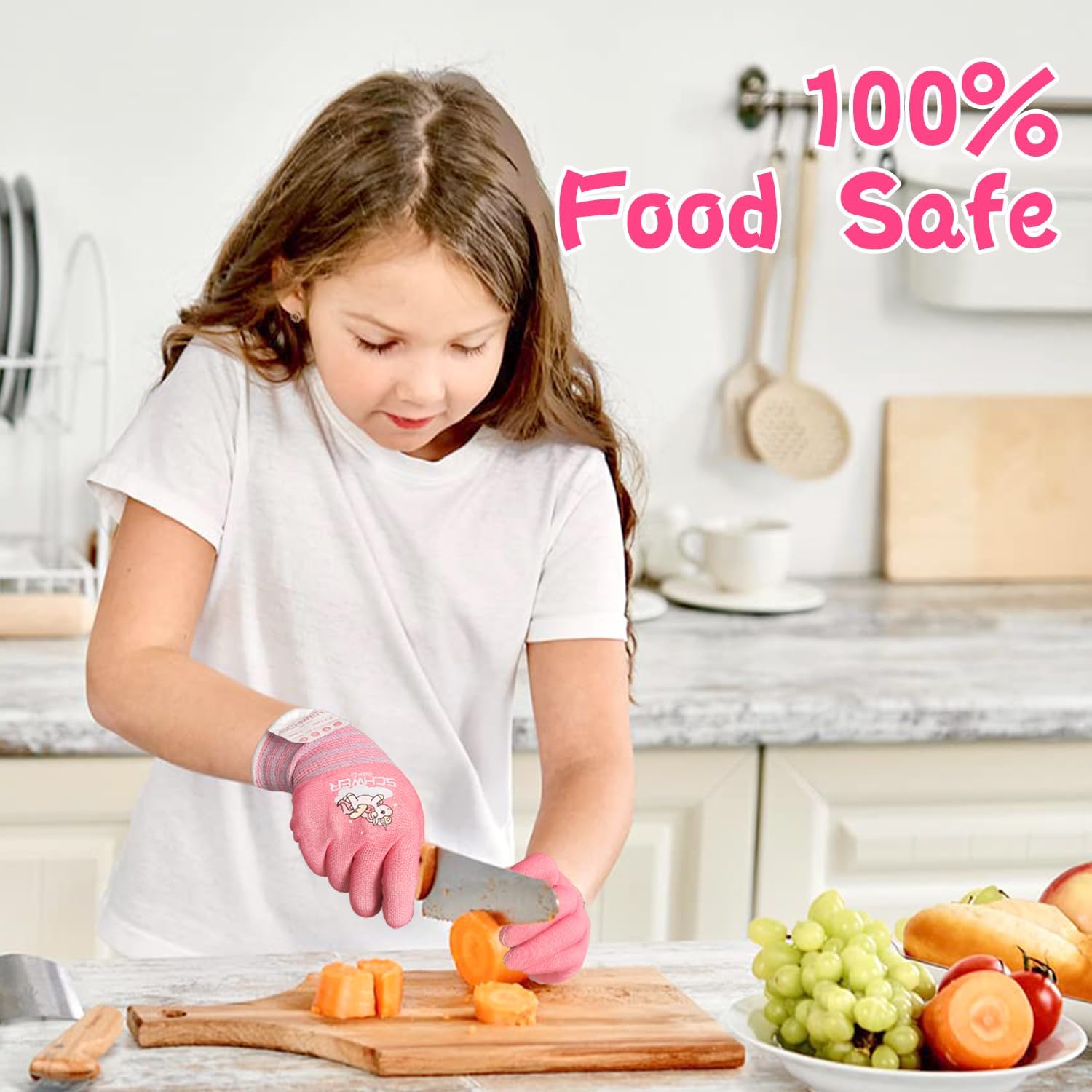 Child wearing pink gloves cutting vegetables on a wooden board with '100% Food Safe' text.