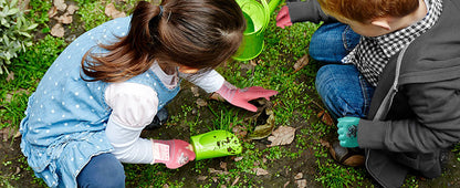 Child holding radishes in a garden
