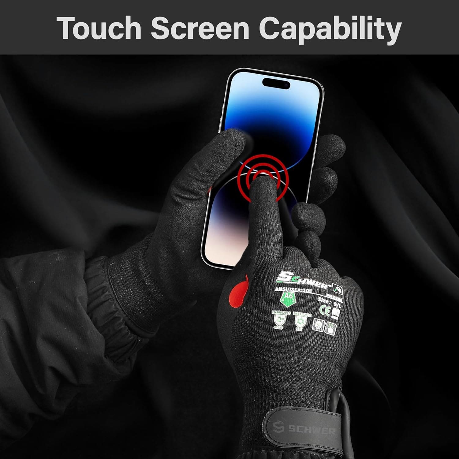 Black winter work gloves with red fingertip using touchscreen smartphone, demonstrating touchscreen capability