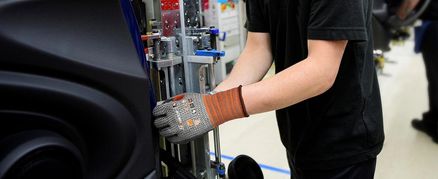 Person wearing a glove working on a mechanical device in an indoor setting