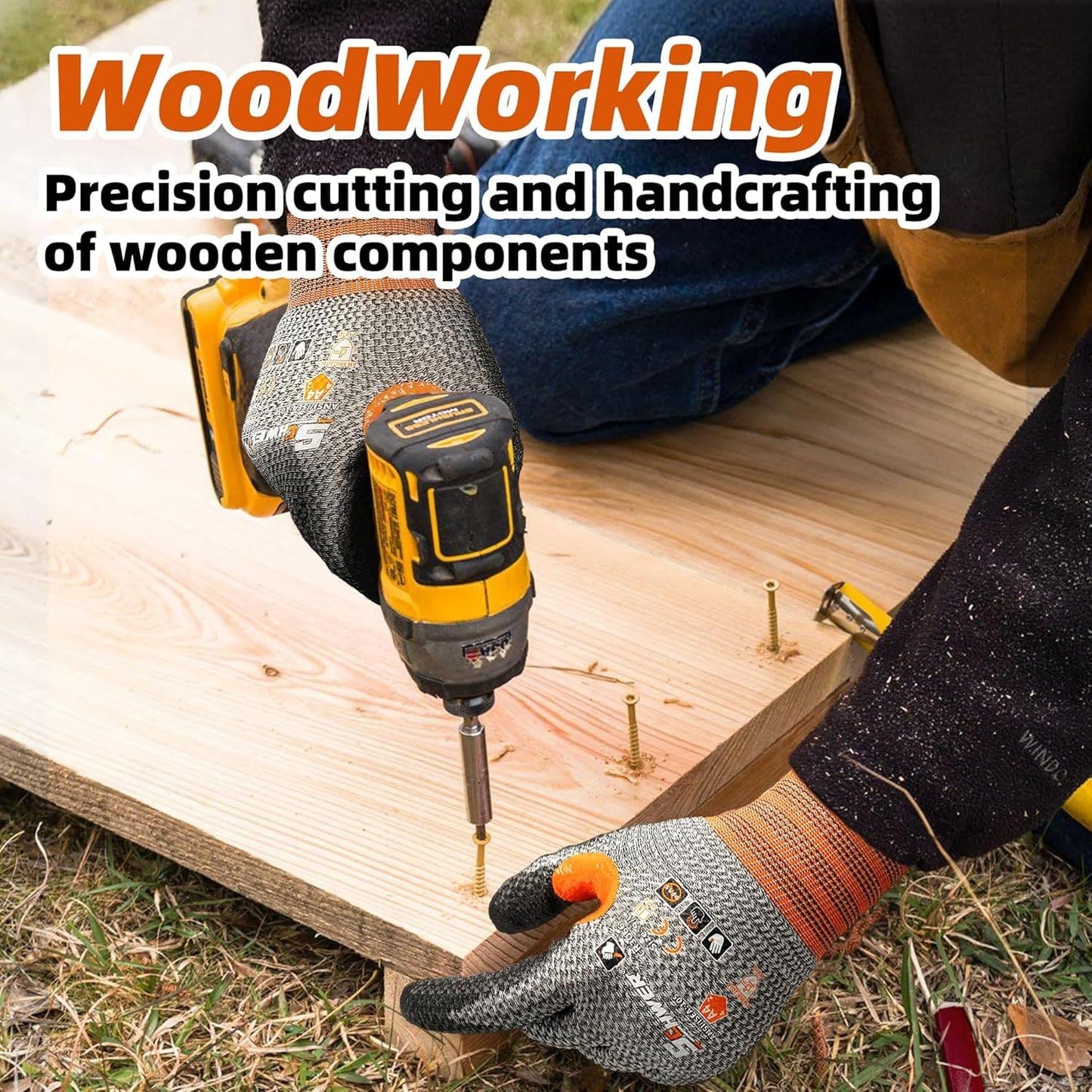 Worker wearing Schwergloves using power drill to screw into wooden board for woodworking project outdoors