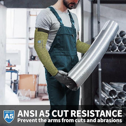 Worker in green cut resistant arm sleeves holding large metal duct in industrial setting