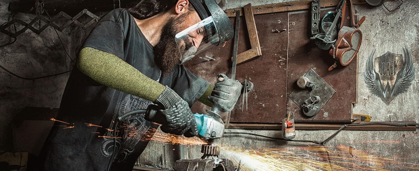 Person welding in a workshop with sparks flying