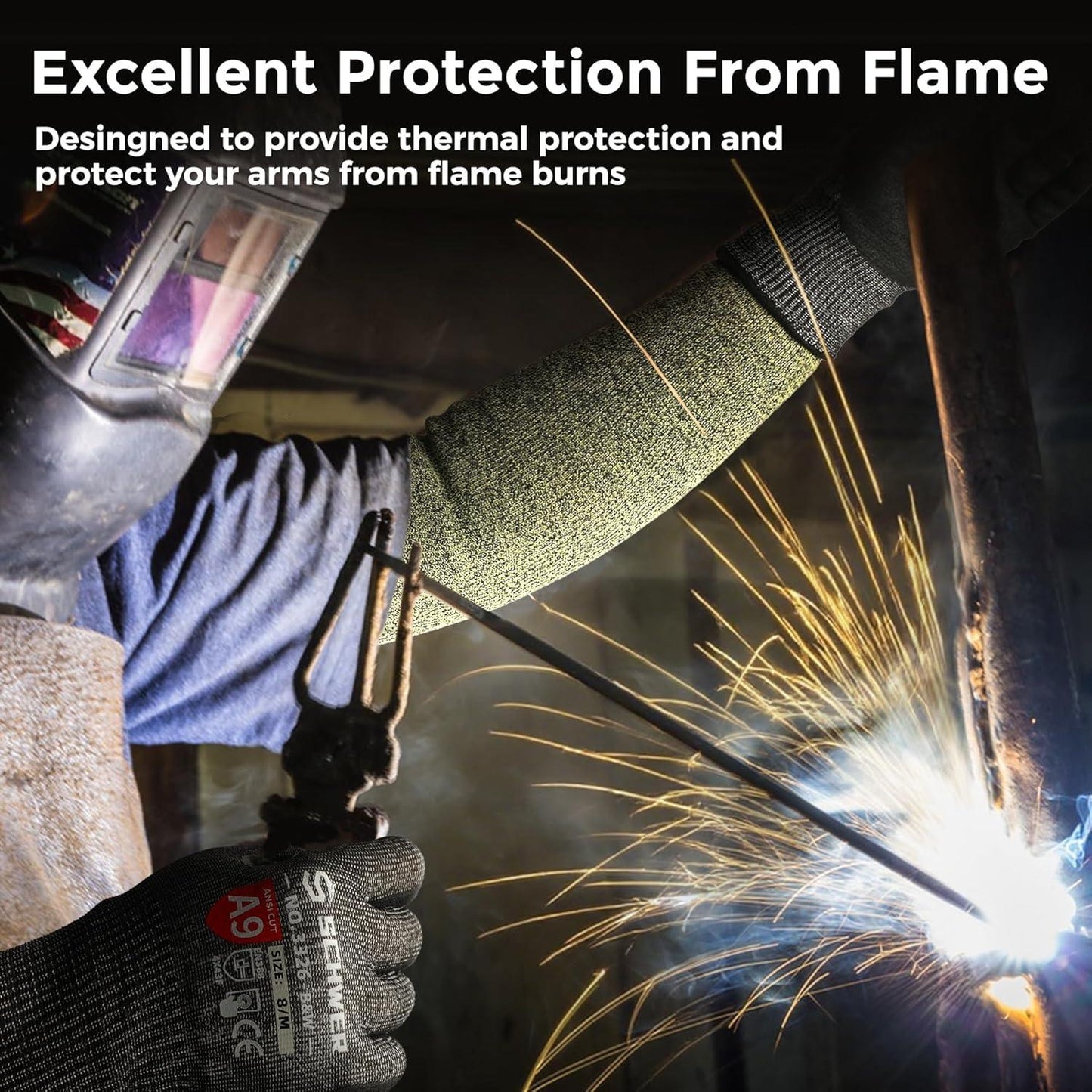 Worker welding metal wearing Schwergloves cut resistant gloves and protective arm sleeves to guard against flame sparks