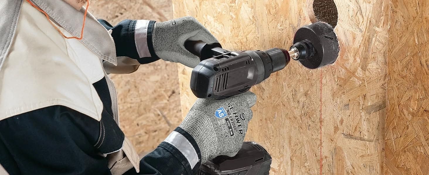 Person using a power drill on a wooden surface
