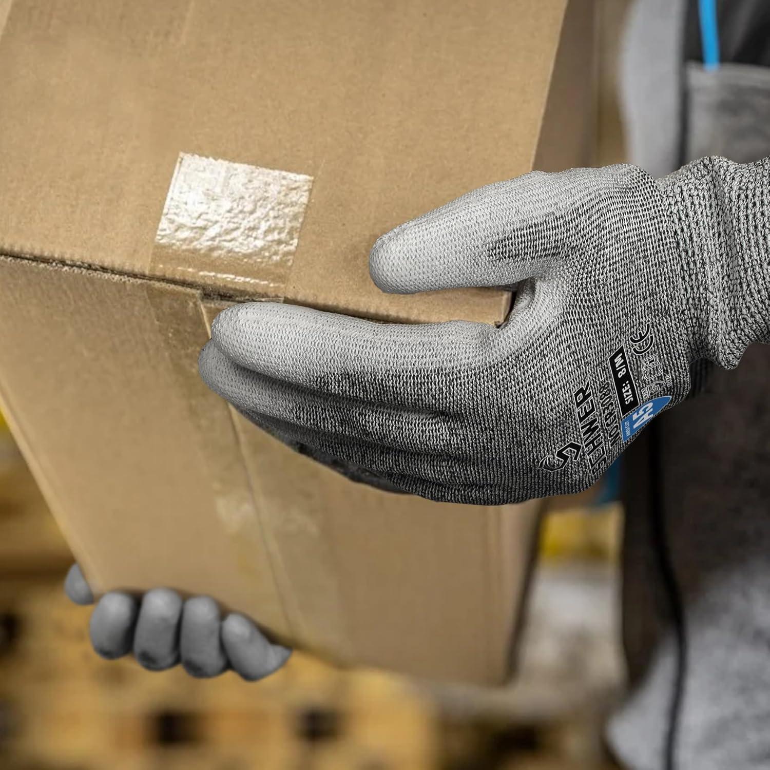 Close-up of hands wearing Schwer cut resistant work gloves holding a sealed cardboard box