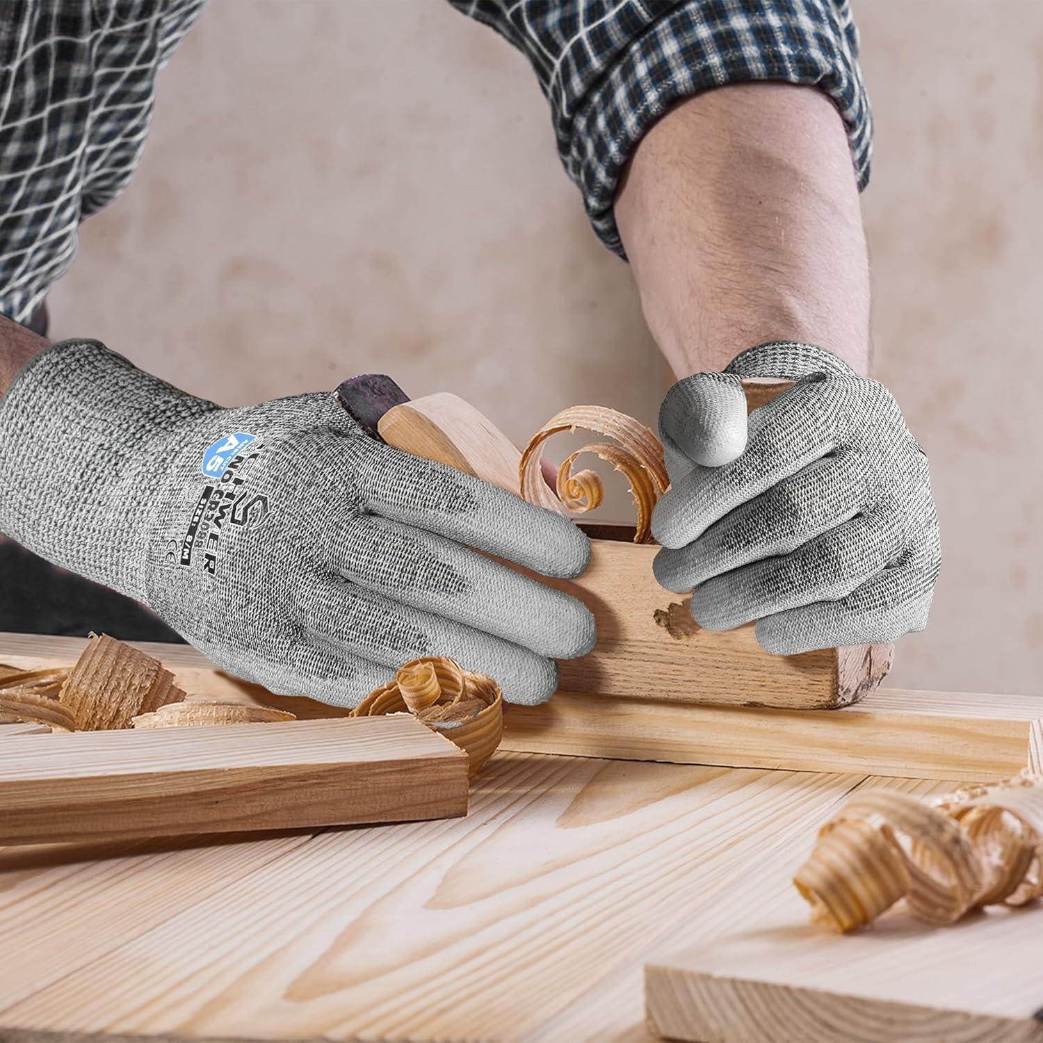 Hands wearing cut resistant work gloves planing wood with a hand plane, wood shavings on table