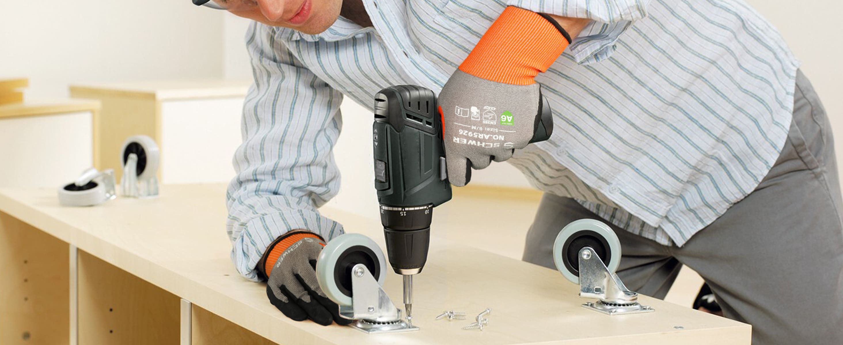Person using a power tool on a wooden surface