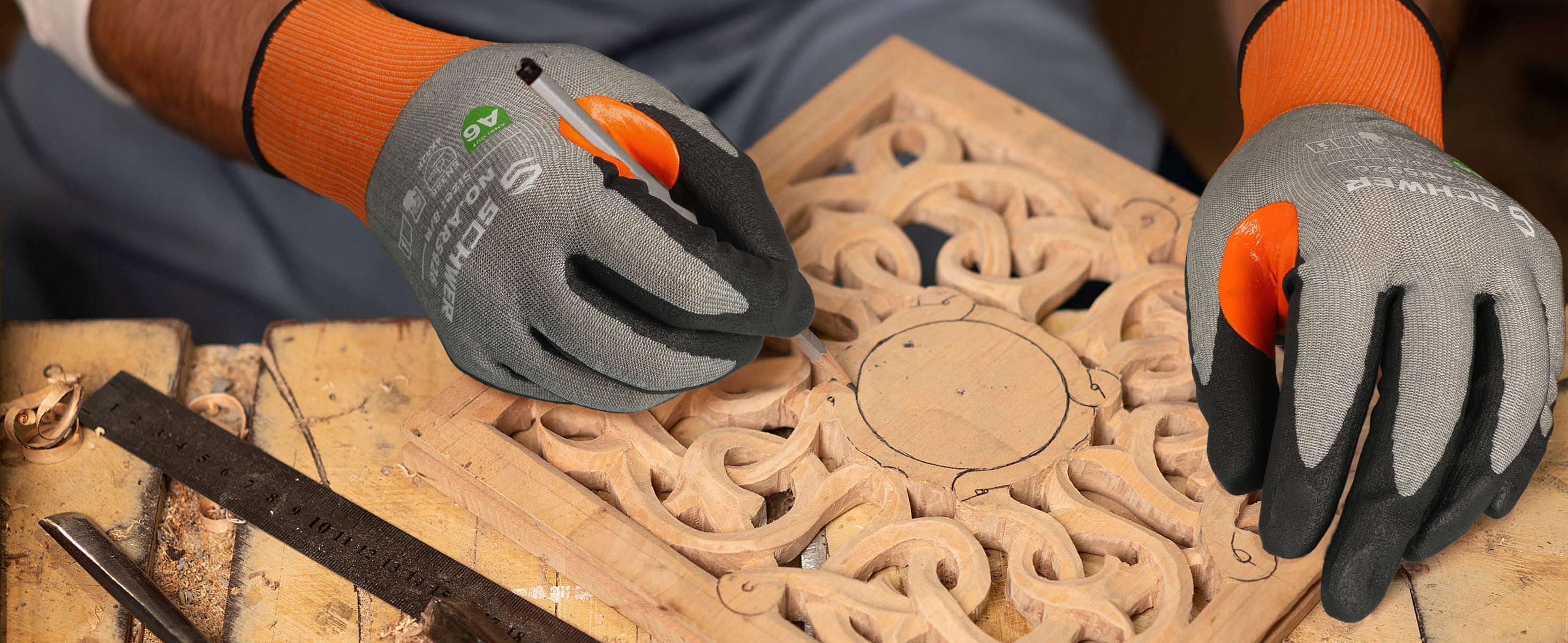 Person wearing gloves using a tool on a wooden surface with intricate carvings