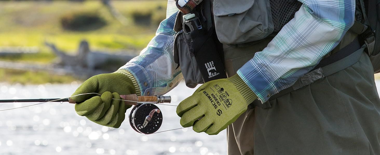 Person fly fishing with green gloves and a blurred natural background