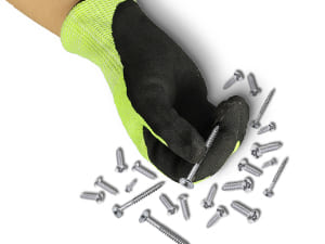 Hand wearing a black glove holding a screwdriver with screws scattered around on a white background