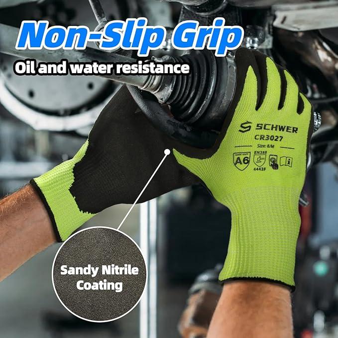 Person wearing Schwer CR3027 work gloves with sandy nitrile coating gripping machinery, showing non-slip, oil and water resistant gloves