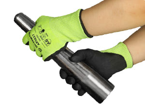 Person wearing green and black gloves holding a metal rod against a white background