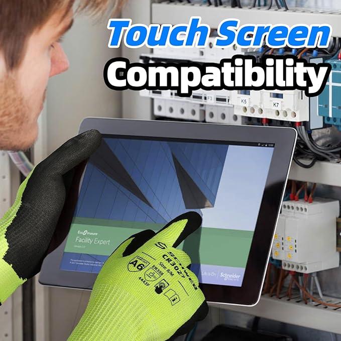 Technician wearing bright green protective gloves using a touchscreen device for electrical panel work, showing touch screen compatibility