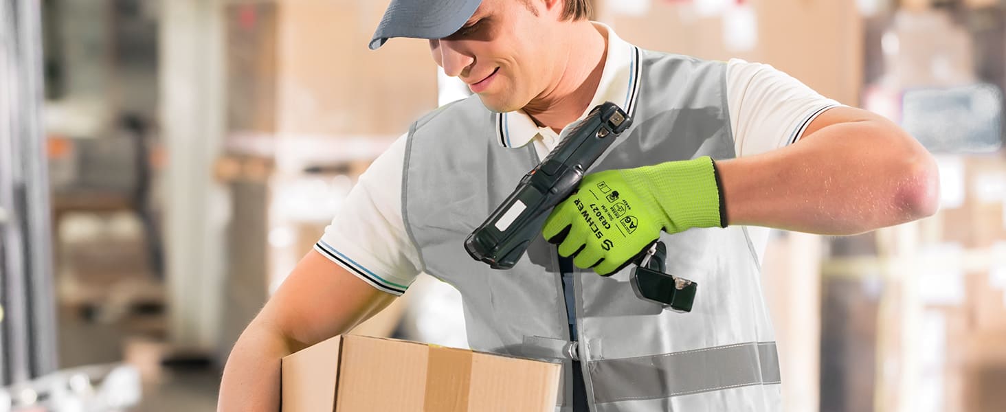Worker using a handheld device to scan a package in a warehouse setting