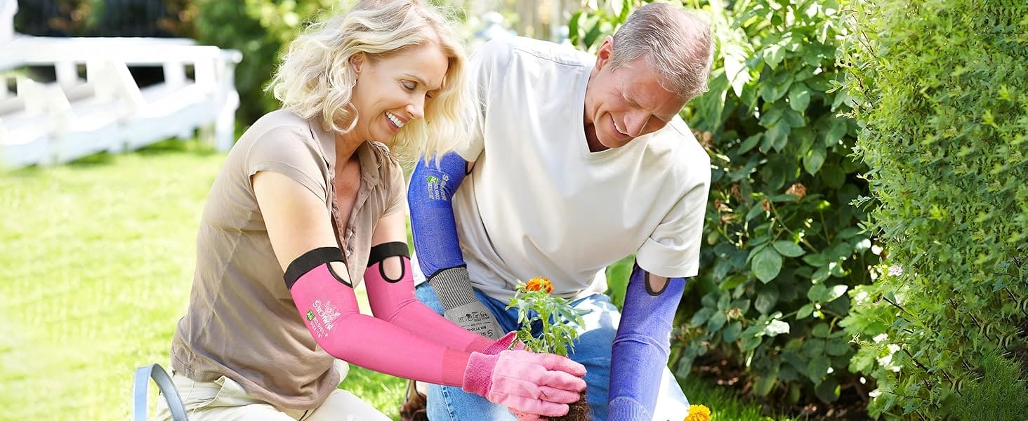 Two people gardening together, one wearing pink gardening gloves and the other blue, with a garden and house in the background.