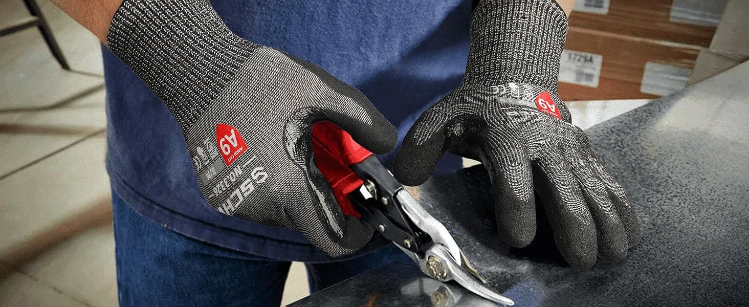 Person wearing gray gloves with red logos holding a pair of pliers.