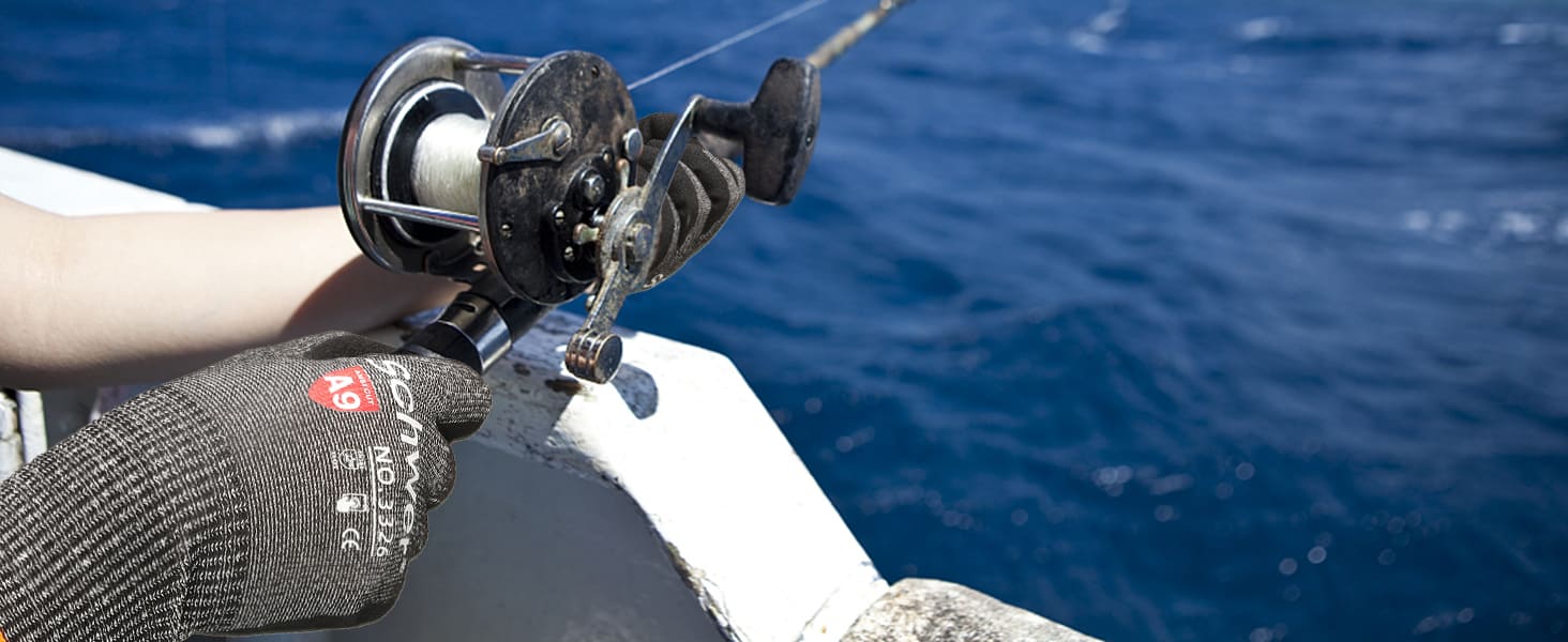 Fishing reel with a person wearing a glove, fishing in the water.