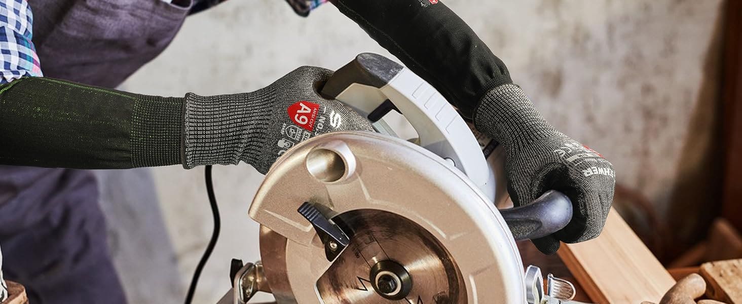 Person using a circular saw with gloves on, focusing on the tool and action.