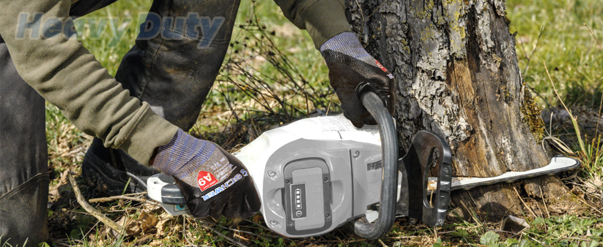 Person using a chainsaw to cut a tree branch, with 'Heavy Duty' branding visible.