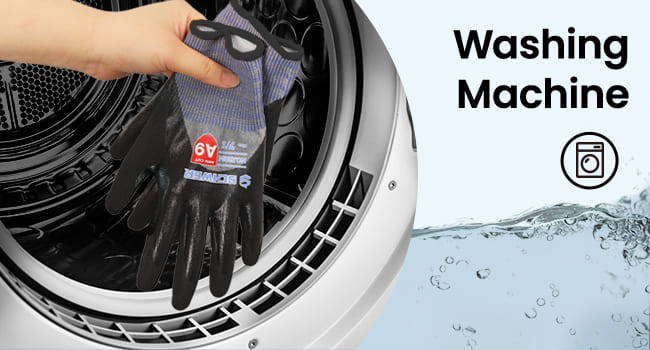 Hand wearing a black glove with a red logo opening a washing machine door.