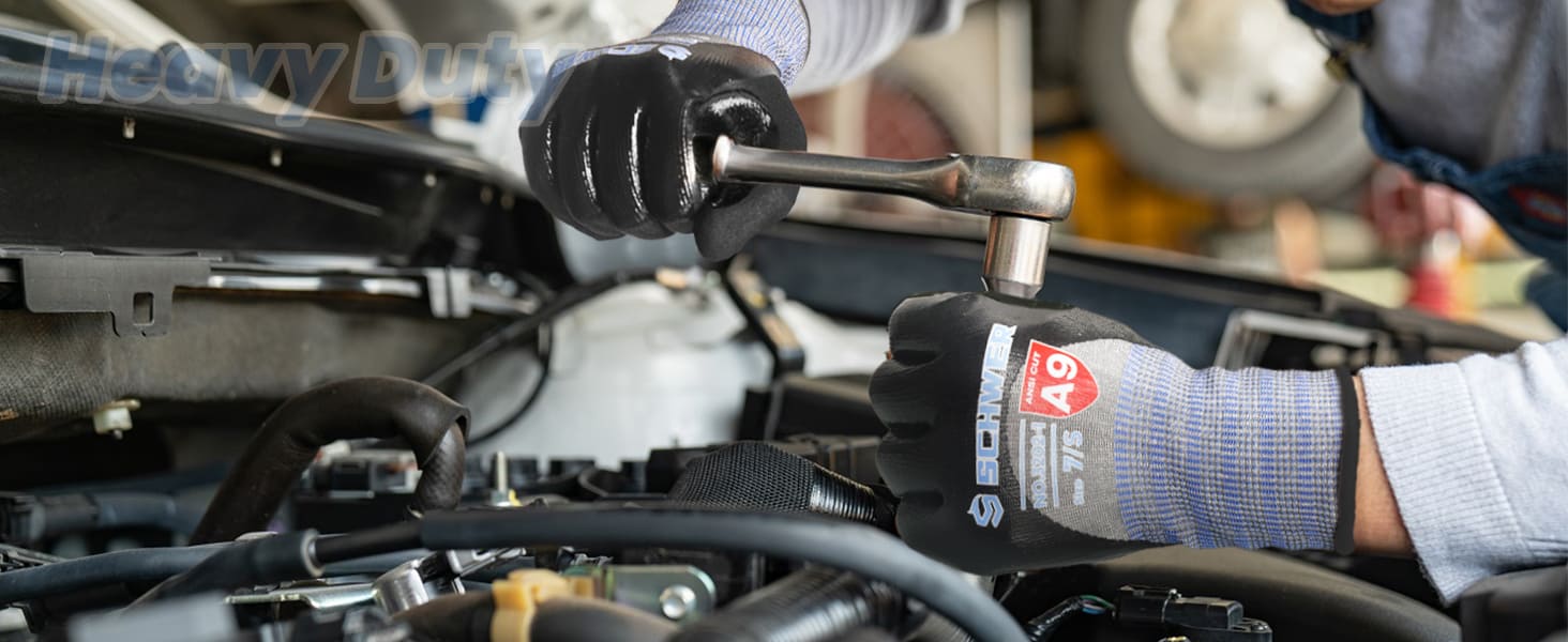 Person working on a vehicle with tools, wearing gloves and a tool with a visible brand logo.