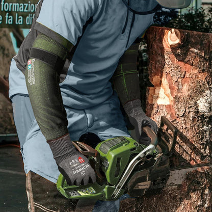 Person using a green chainsaw to cut a log outdoors