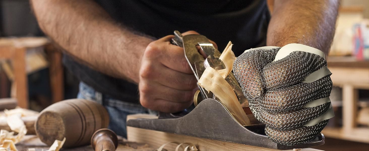 Person using a hand plane on wood with a workshop background