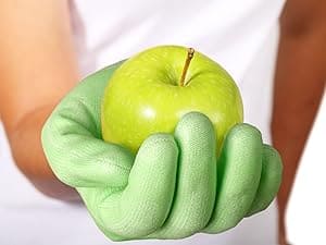 Green apple held in a green glove against a white background