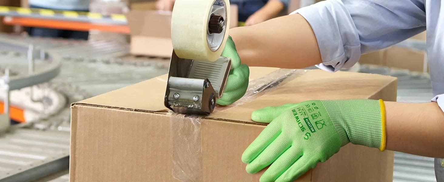 Person taping a cardboard box with a roll of tape, wearing green gloves.