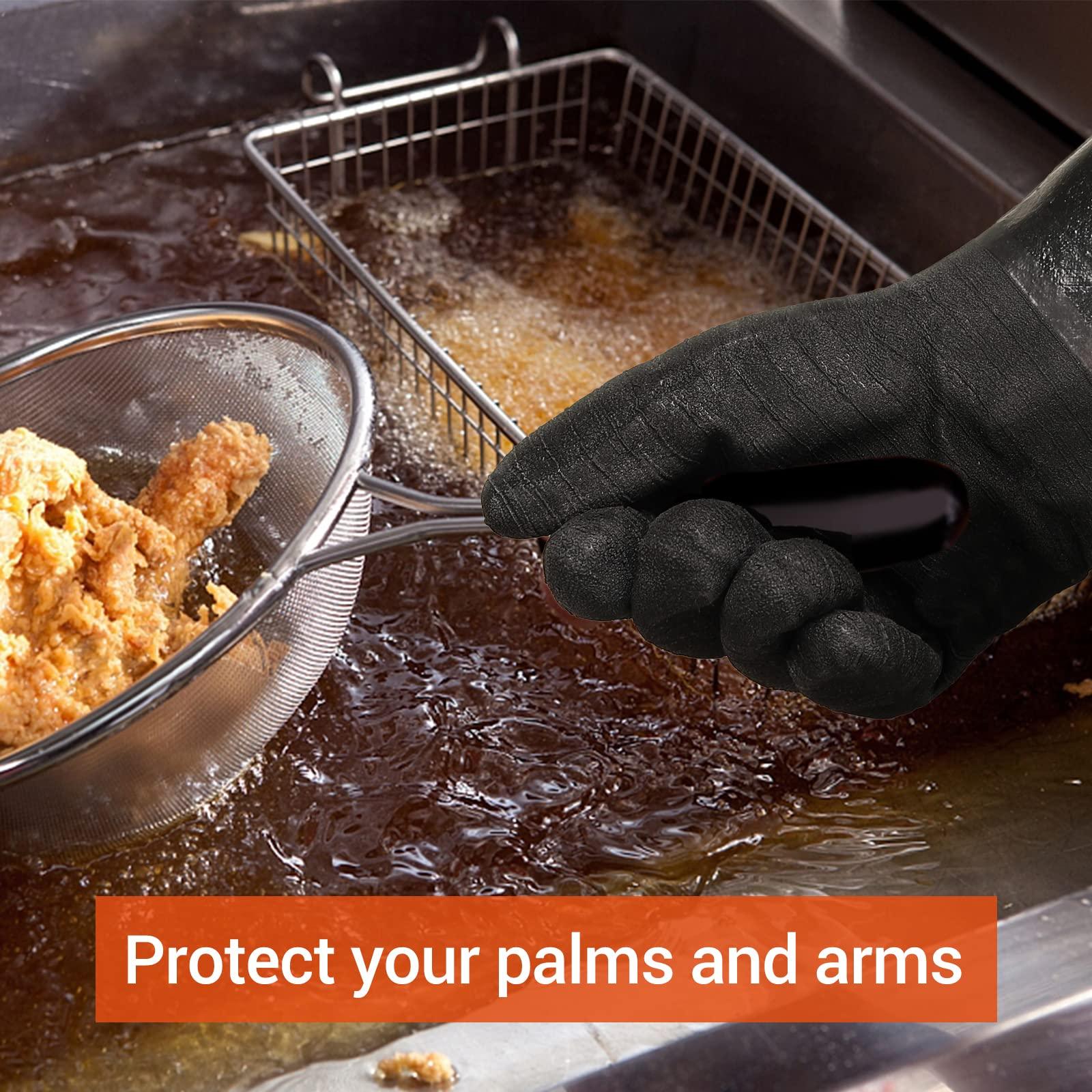 Hand wearing black protective glove holding a wire strainer with fried chicken over hot oil fryer