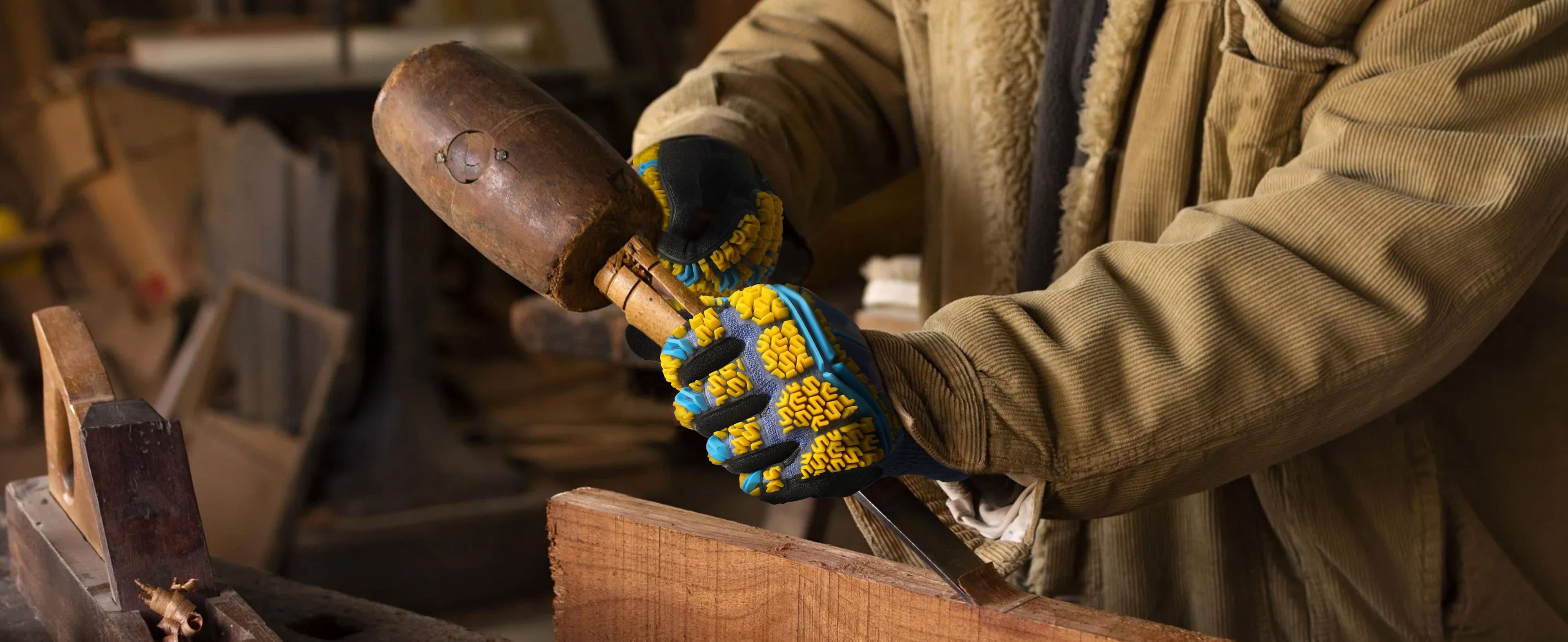 Person working with a hammer and an anvil in a workshop setting