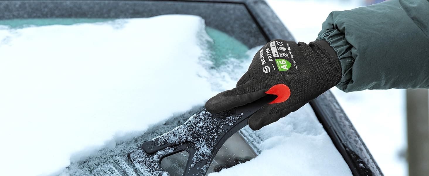 Person using a snow scraper on a car window with a glove on