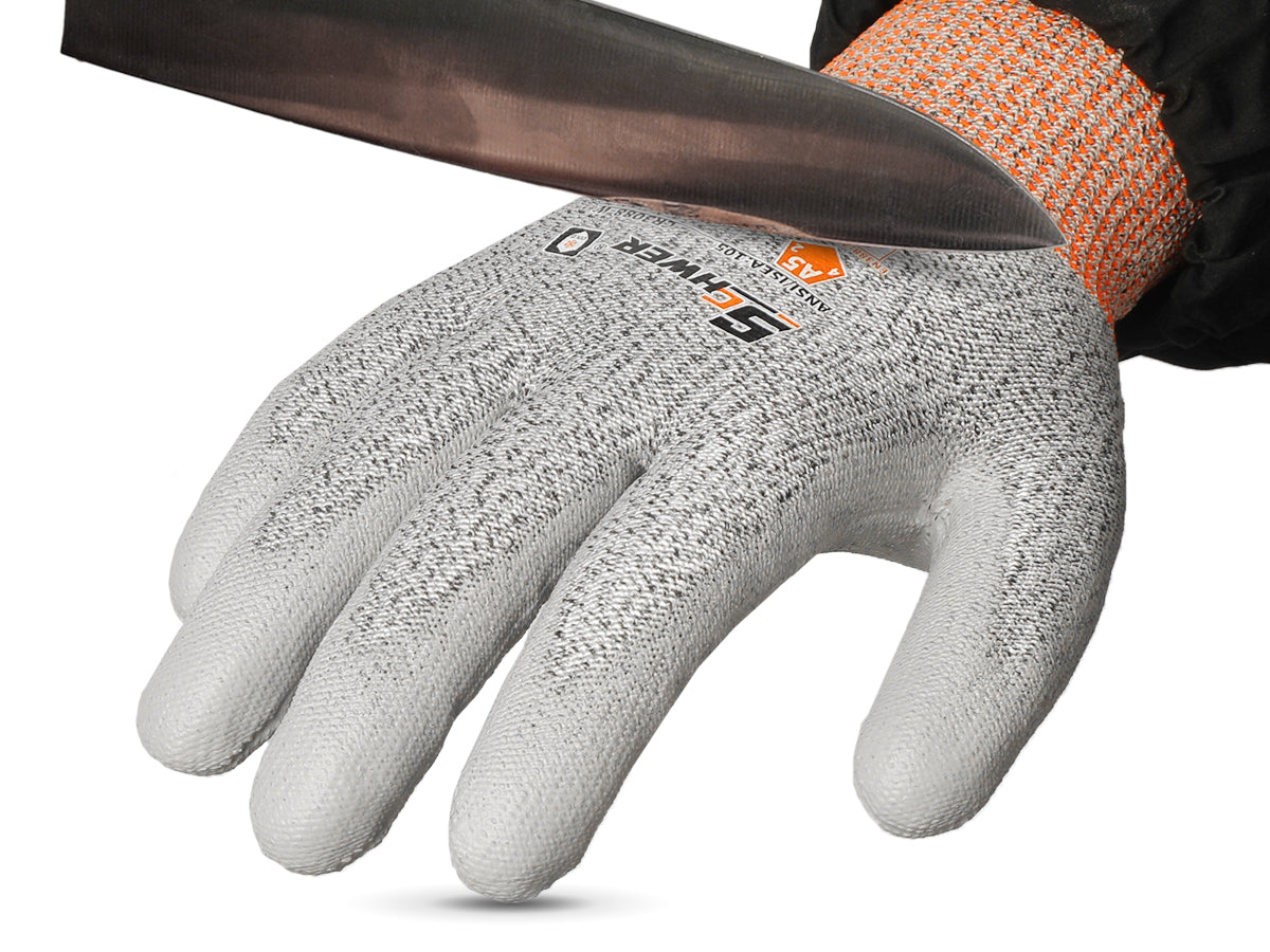 Gray cut-resistant glove with orange cuff on a white background