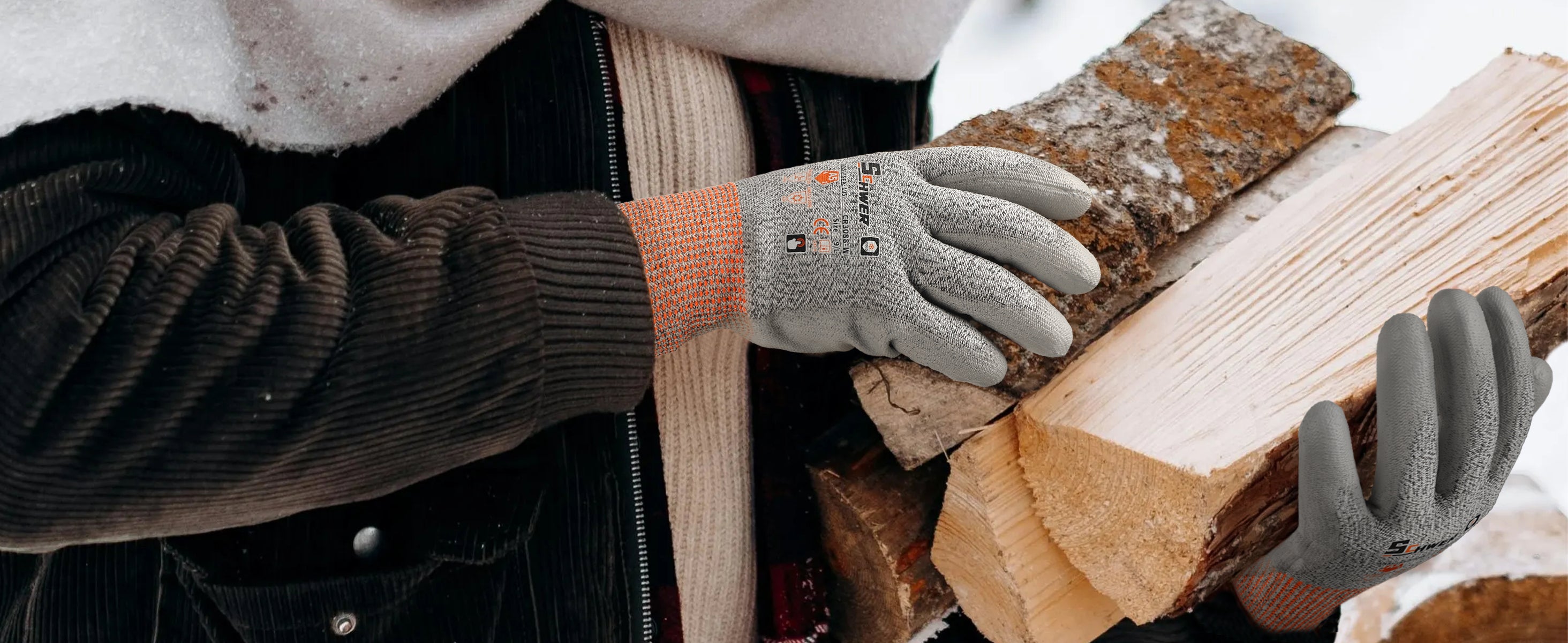 Person wearing gloves holding a bundle of firewood