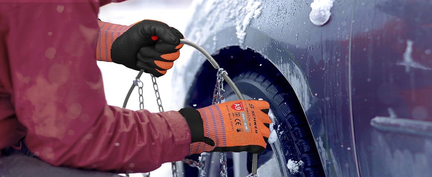 Person using a car tire chain on a snow-covered vehicle