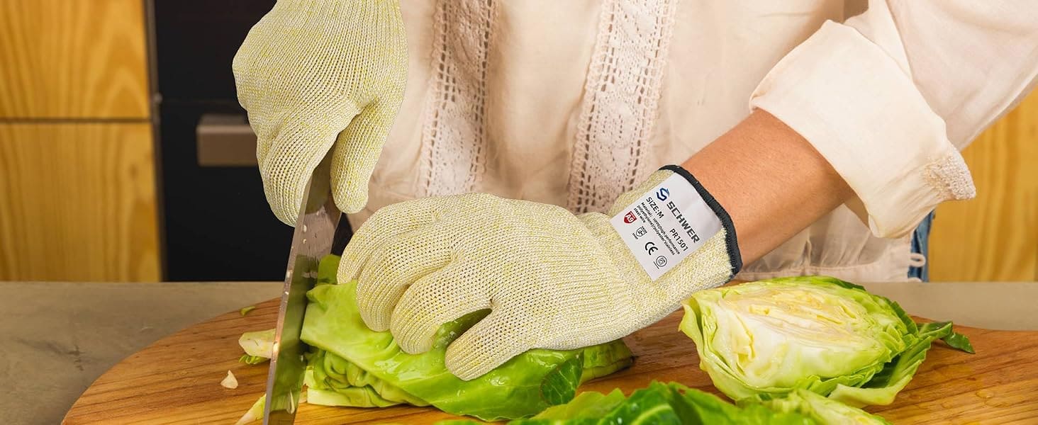 Person wearing gloves and cutting lettuce on a wooden board