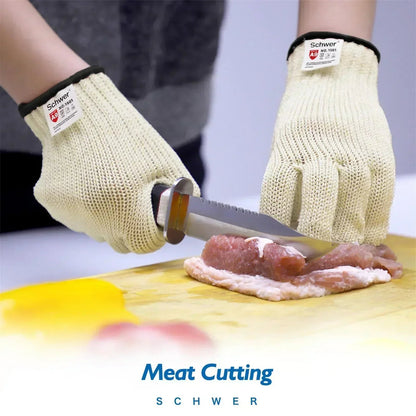 Person wearing cut-resistant Schwer gloves slicing raw meat on wooden cutting board with a knife