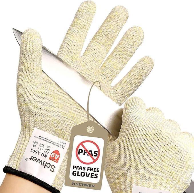 Cut-resistant kitchen gloves holding a sharp knife with PFAS free tag on white background