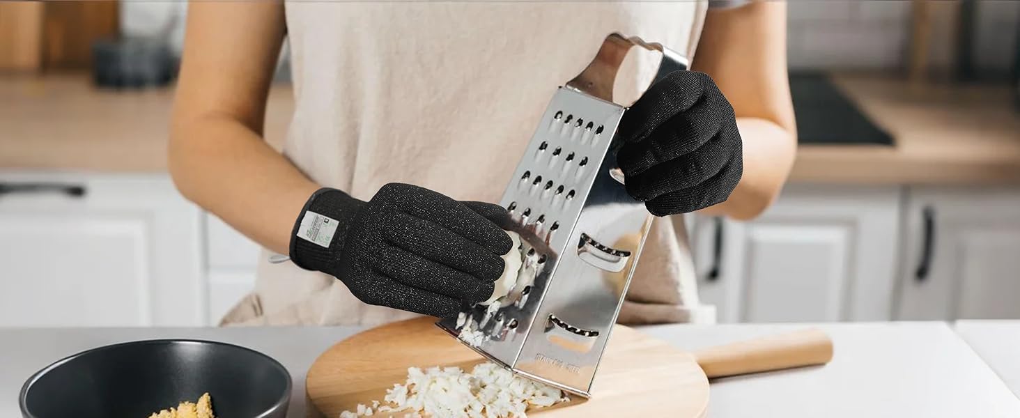 Person using a box grater with gloves on in a kitchen setting