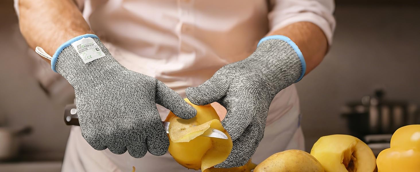Person wearing cut-resistant gloves cutting a yellow fruit with a blurred kitchen background