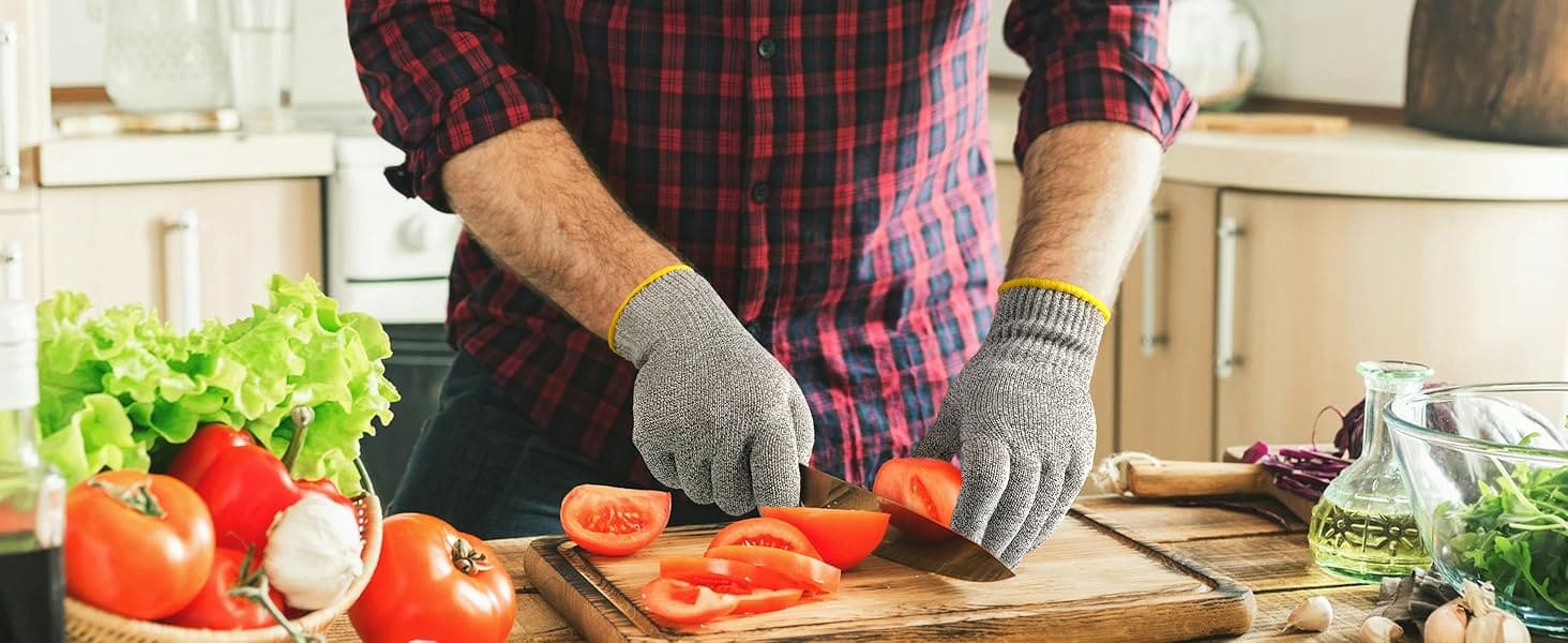 Person cutting vegetables on a wooden cutting board in a kitchen.