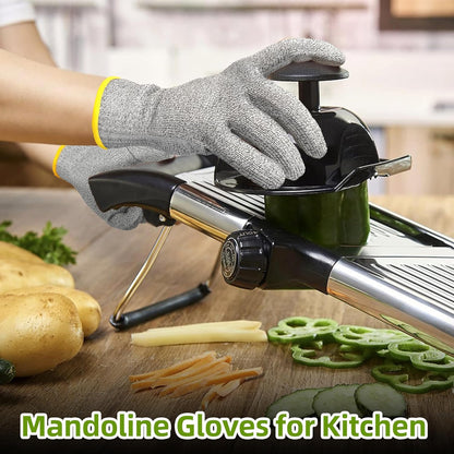Hands wearing cut-resistant gloves slicing green bell pepper on mandoline slicer in kitchen