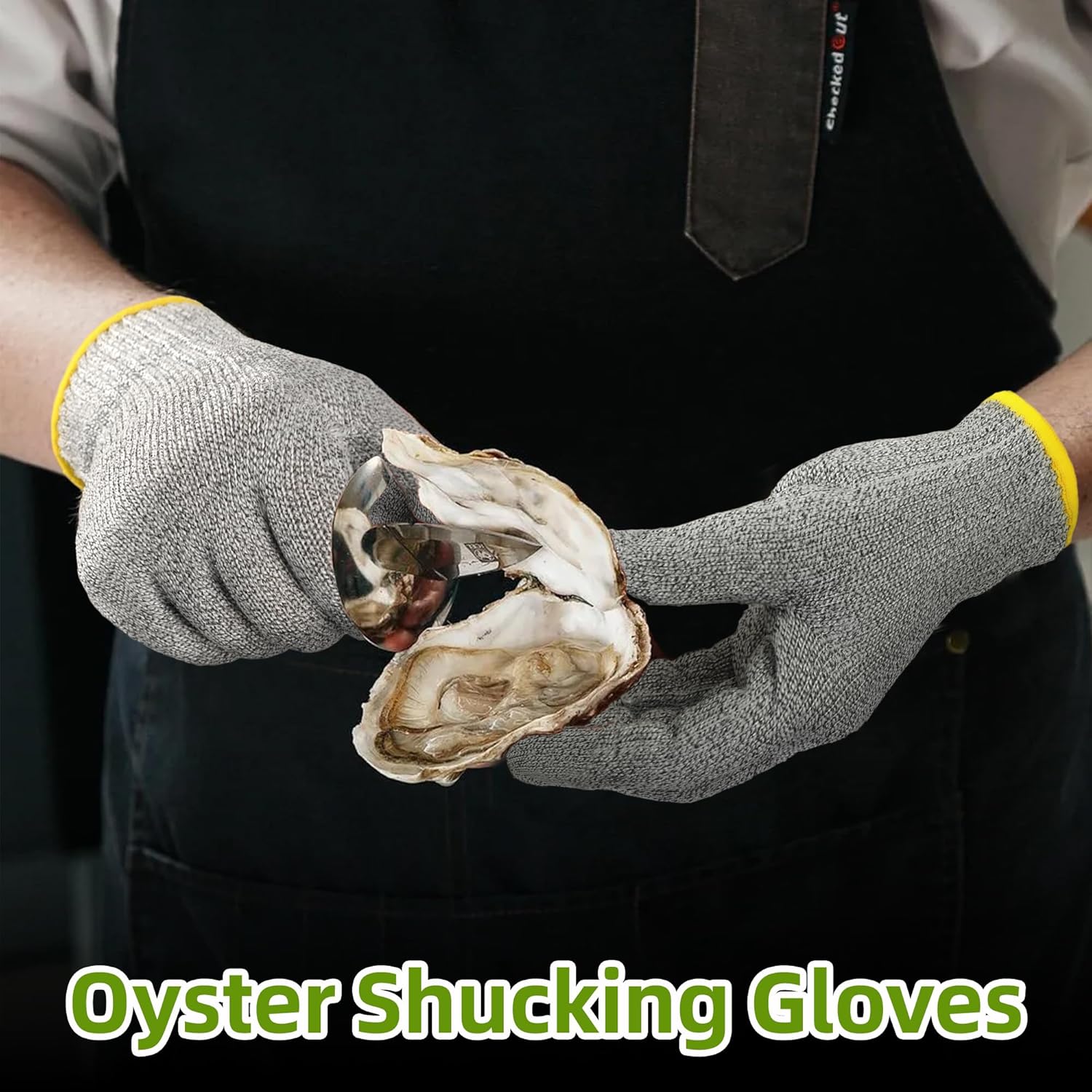 Person wearing gray cut-resistant oyster shucking gloves holding an opened oyster with a shucking knife