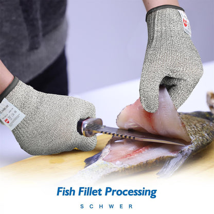 Person wearing cut-resistant gloves filleting fish with a serrated knife on a wooden board