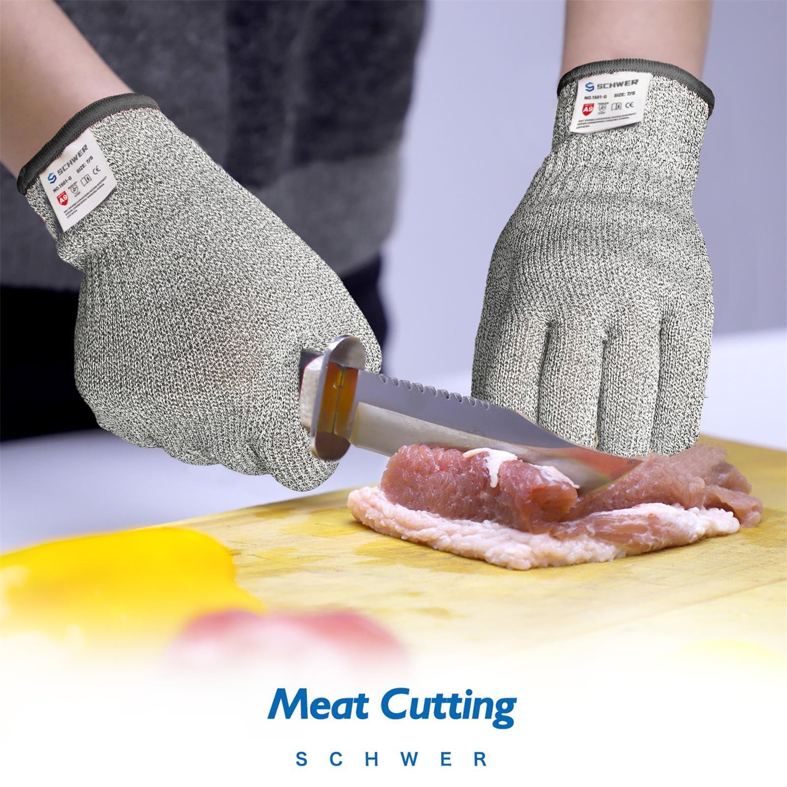 Hands wearing Schwer cut-resistant gloves slicing raw meat on a wooden cutting board