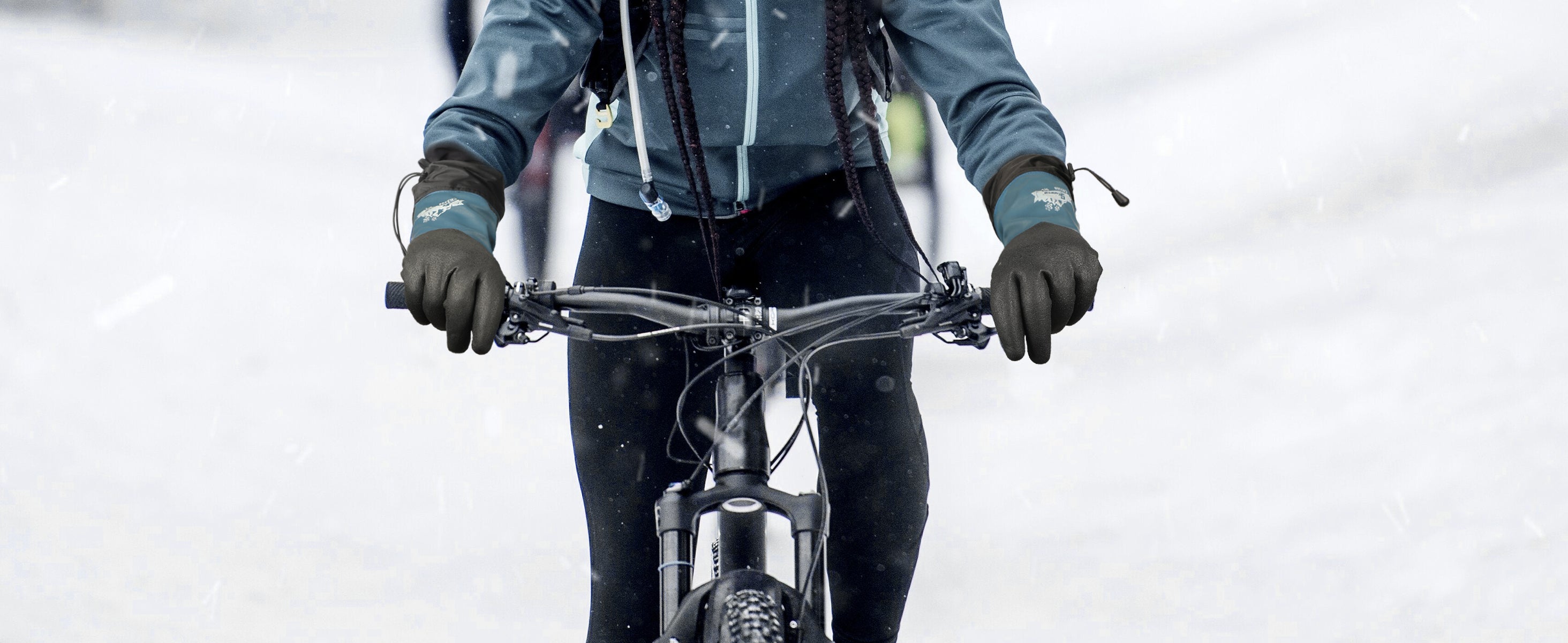 Person riding a bicycle in a snowy landscape